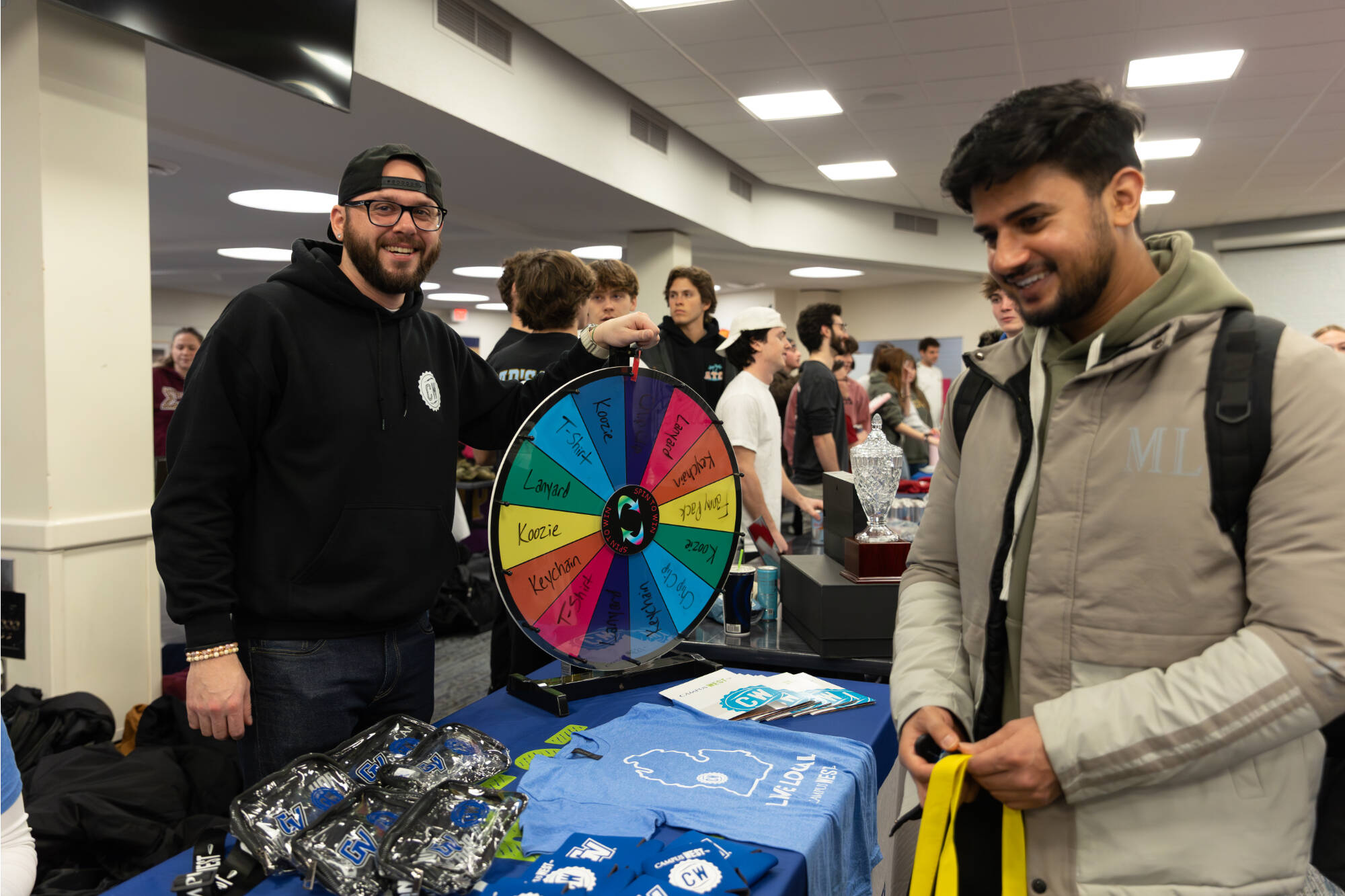 Staff help student spin the prize wheel